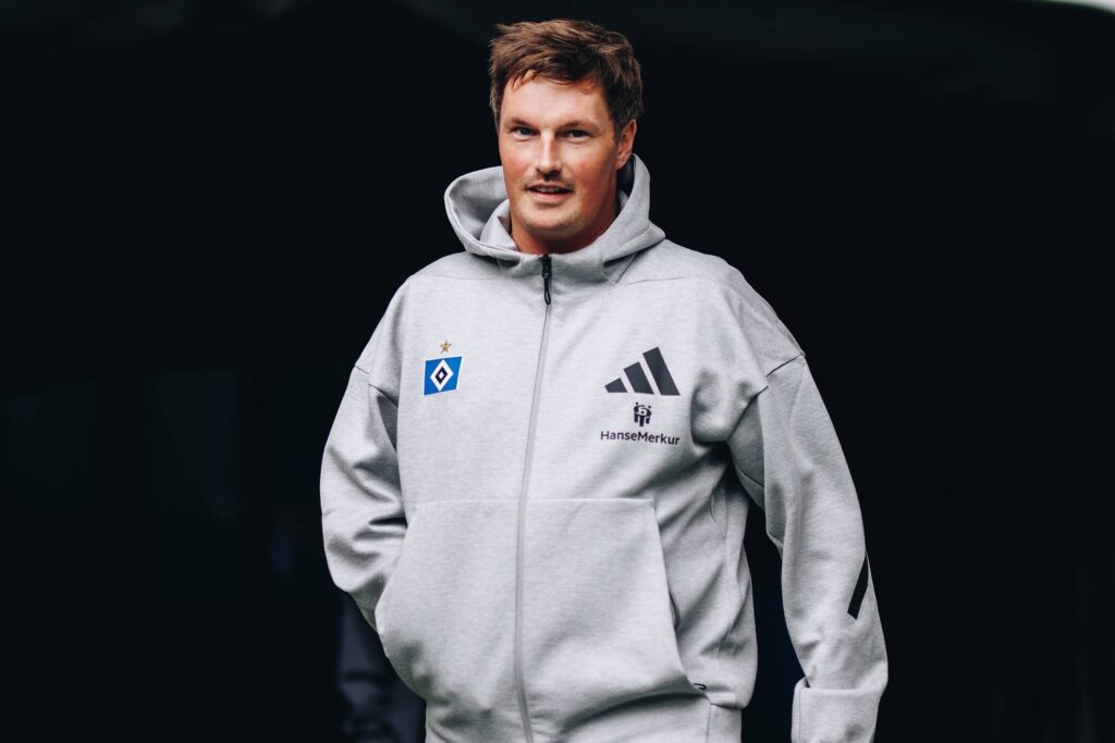 A man in a grey hoodie and black jacket