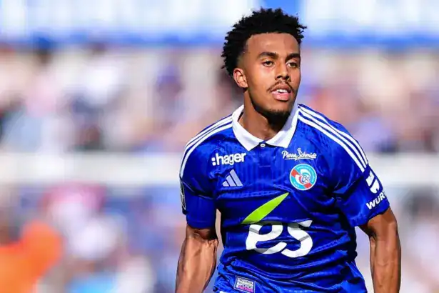 Guela Doué wearing a blue RC Strasbourg Alsace home jersey during a match