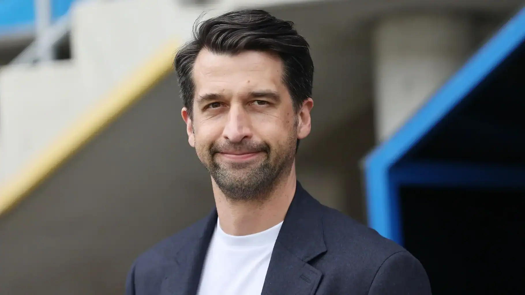 Portrait of Jonas Boldt wearing a dark blazer and white t-shirt